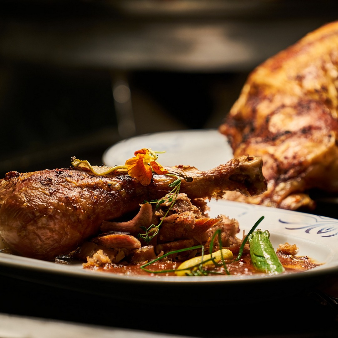 Baked half chicken with sauce and rustic lettuce